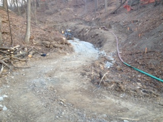 Preparing the site for a Retain-A-Rock retaining wall system at a water outfall channel in Hamilton, ON.