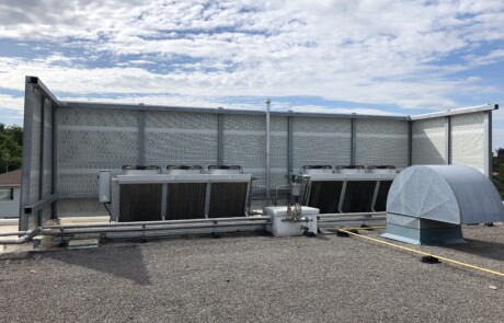 PVC post-and-panel rooftop noise barrier system on the roof of a food processing facility in the Greater Toronto Area, ON.