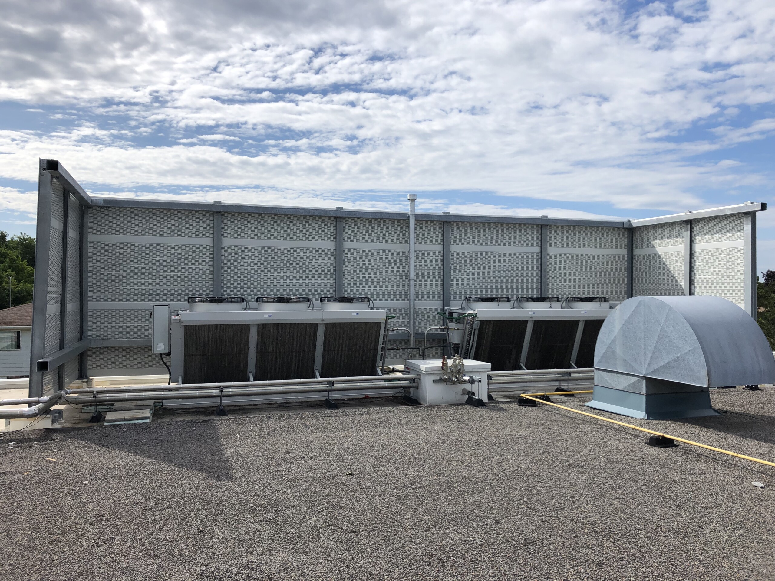 PVC post-and-panel rooftop noise barrier system on the roof of a food processing facility in the Greater Toronto Area, ON.