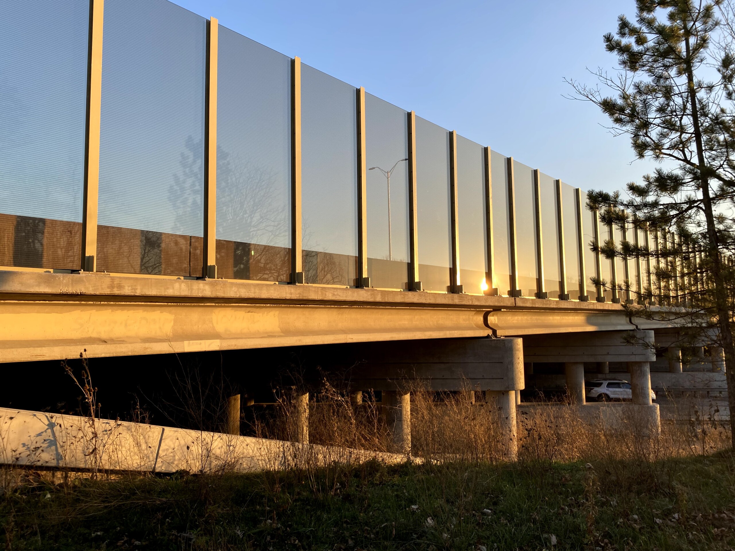 Transparent noise barrier panels with Bird Guard installed on a bridge on the Reagan Memorial Highway (I-88) in Elmhurst, IL.