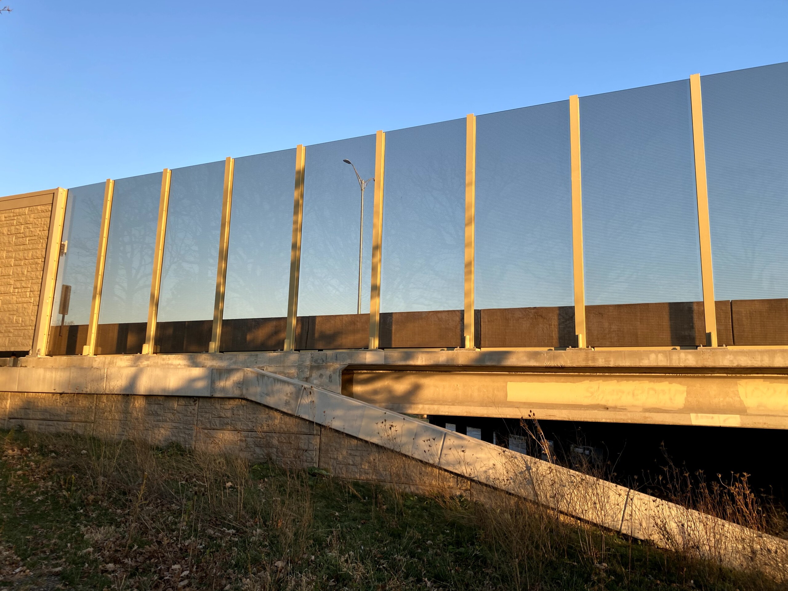 Transparent noise barrier panels with Bird Guard installed on a bridge on the Reagan Memorial Highway (I-88) in Elmhurst, IL.
