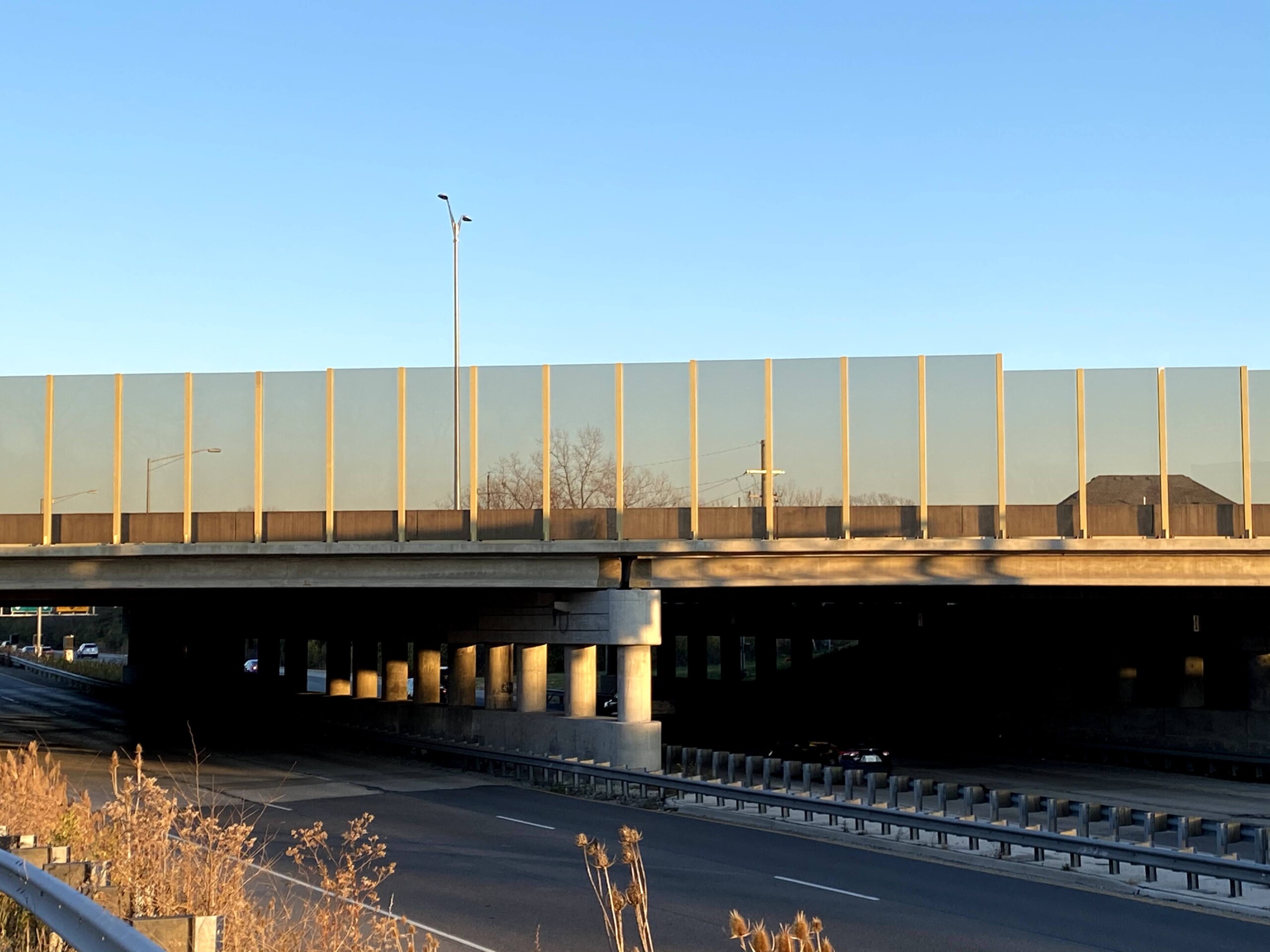 Transparent noise barrier panels with Bird Guard installed on a bridge on the Reagan Memorial Highway (I-88) in Elmhurst, IL.