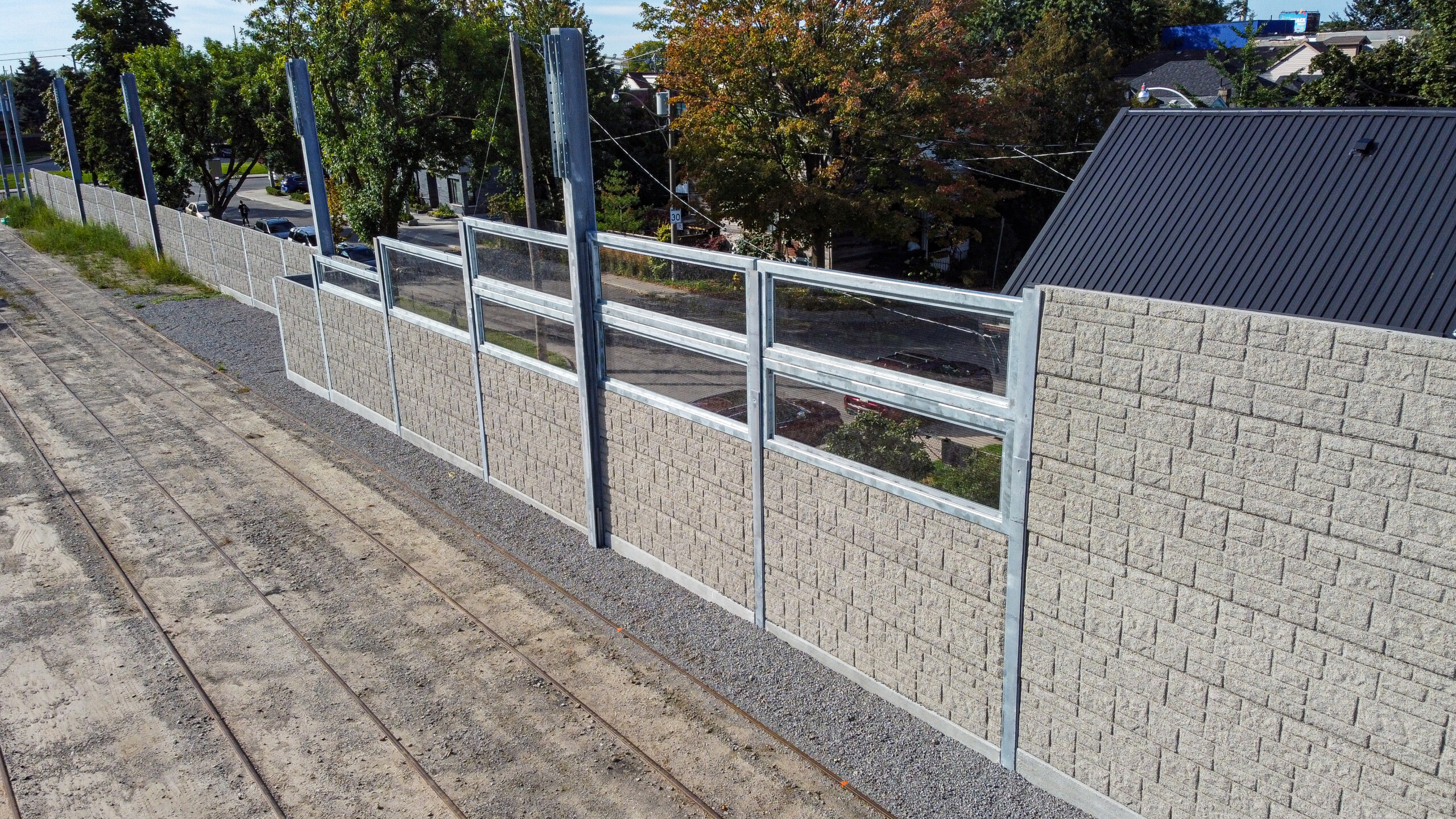 An acoustic wall with Acrylite transparent "window-like" panels along the Toronto Transit Commission's (TTC) Russell Carhouse's property line in Toronto, Ontario.