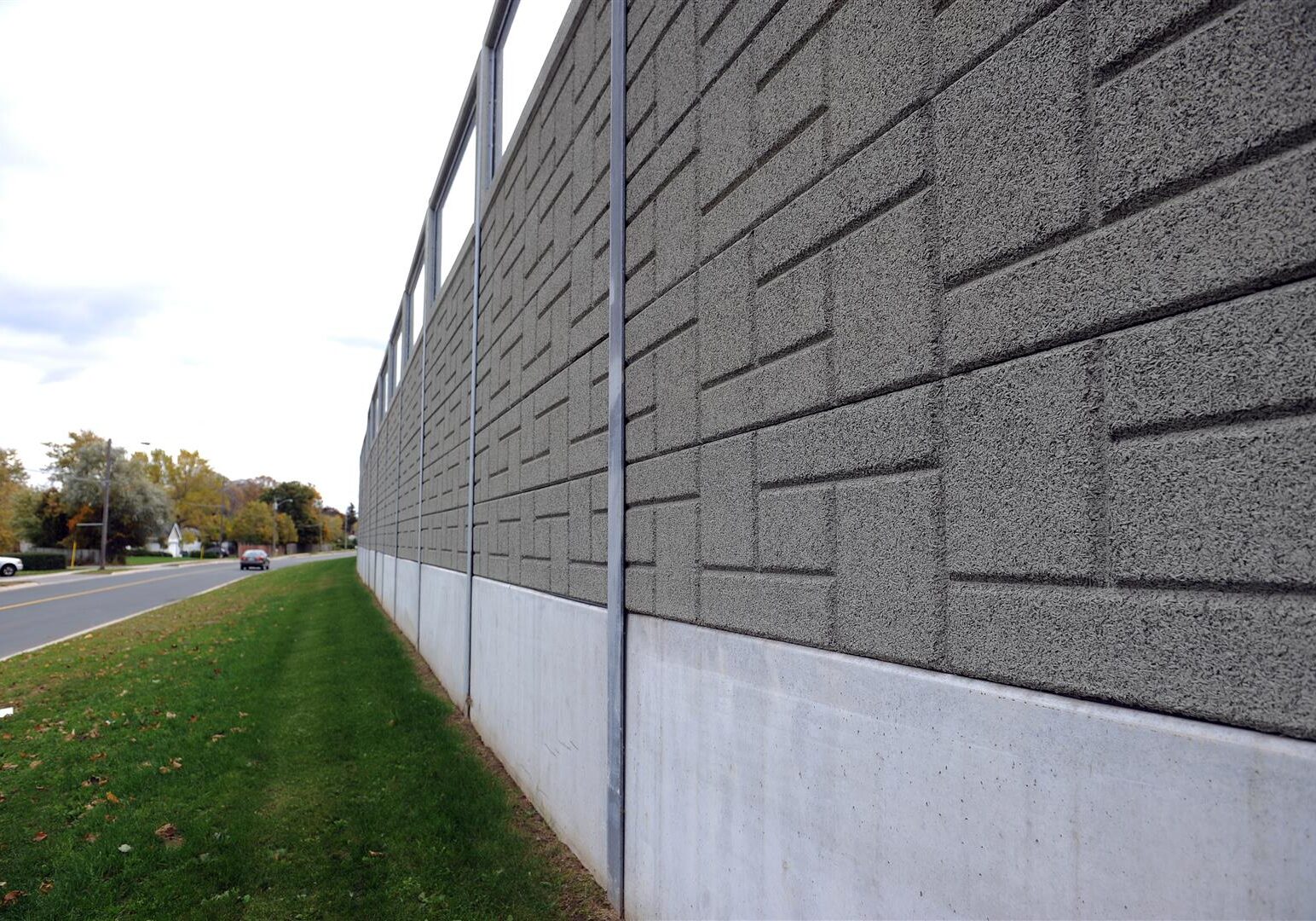 A precast noise wall topped with transparent panels in St. Catharines, ON.